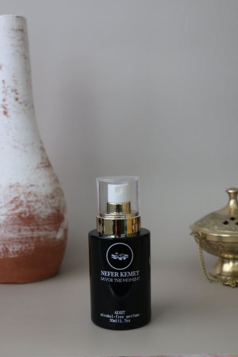 50 ml black perfume bottle around a vase and incense burner