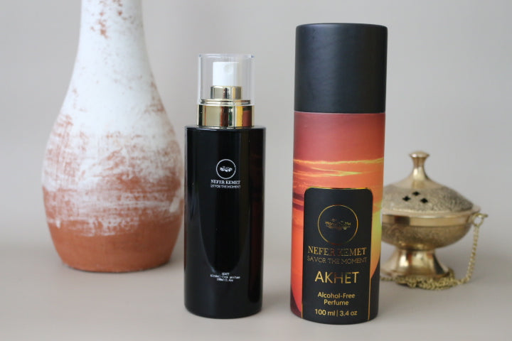 100 ml black perfume bottle around a vase and incense burner next to the sunrise packaging